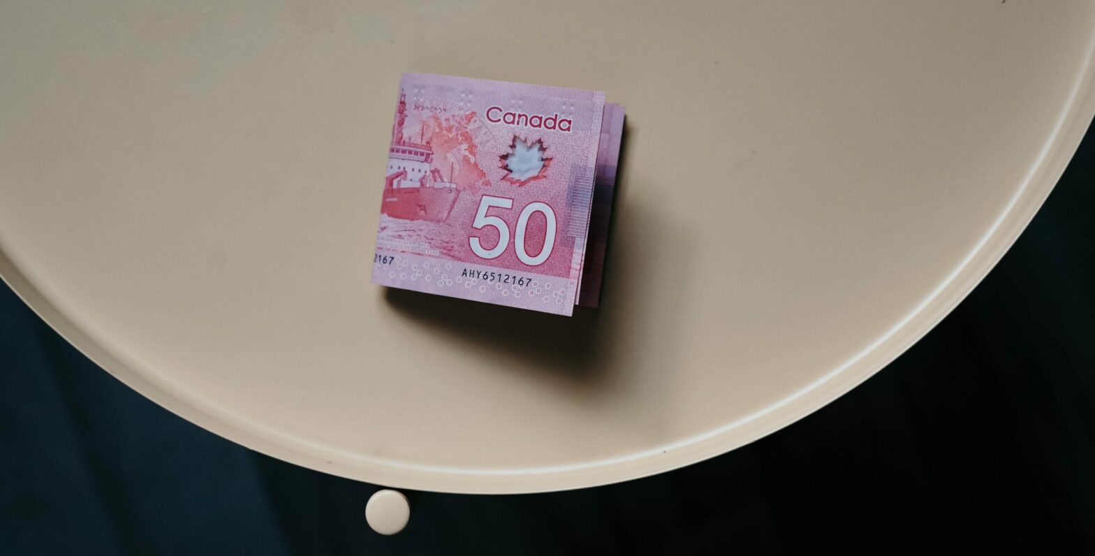 A photo of two Canadian 50 dollar bills sitting on a table