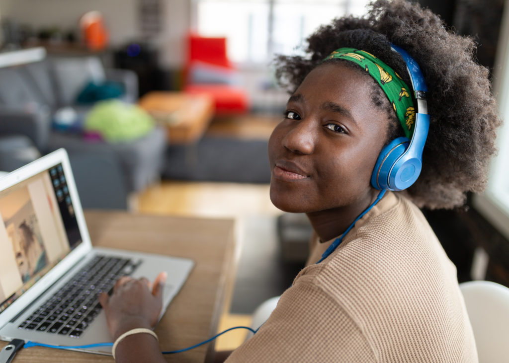 Afro American girl using laptop to connect with online training sessions
