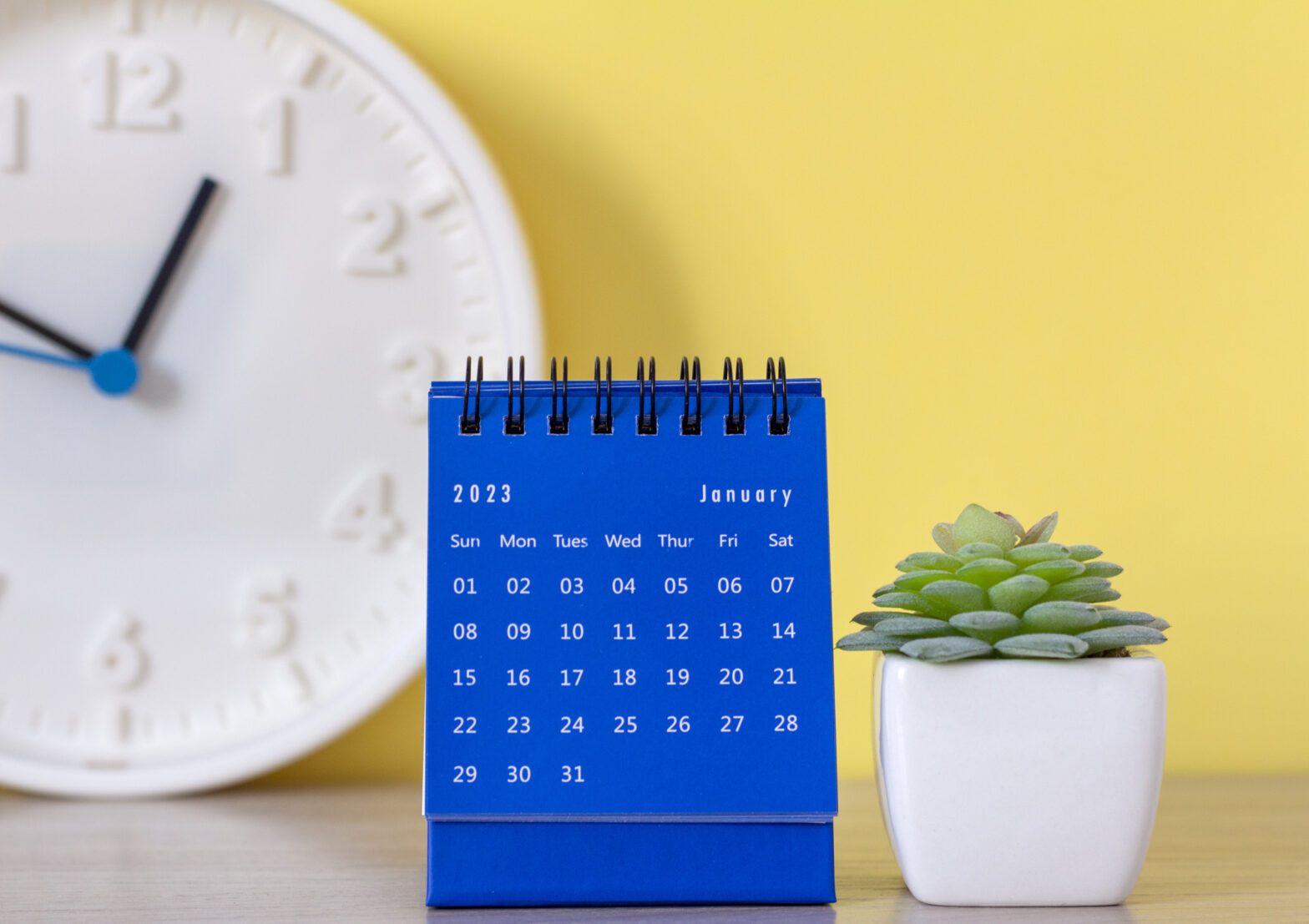 Desktop calendar for January 2023 on a yellow background